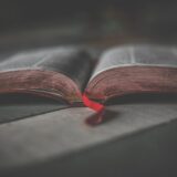 close up photo of an opened religious book